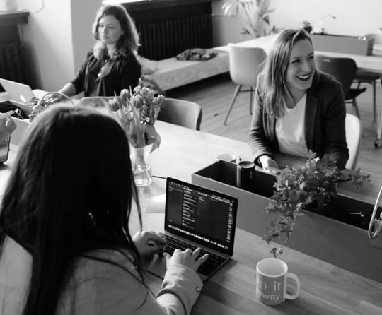 women working on their notebooks in a comfy environment