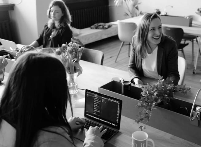 women working on their notebooks in a comfy environment